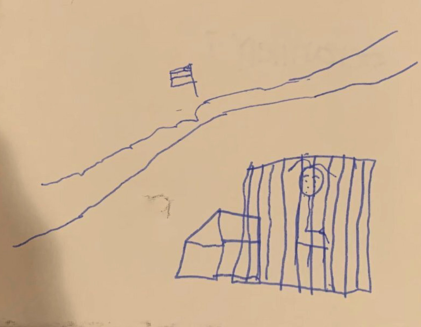 An unidentified child living at a tent encampment in Matamoros, across the border from Brownsville, Texas, draws herself in a cage.